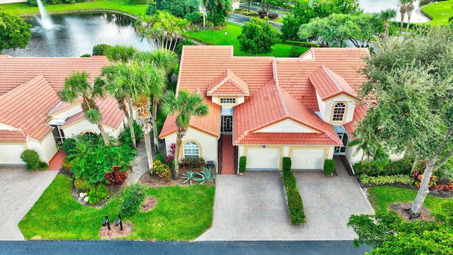 birds eye view of property with a water view