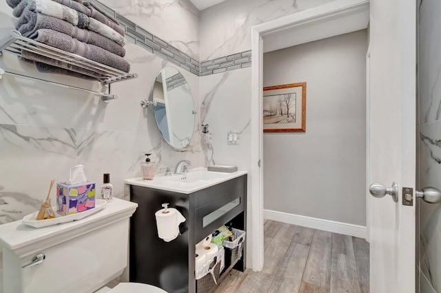 bathroom featuring hardwood / wood-style floors, vanity, and toilet