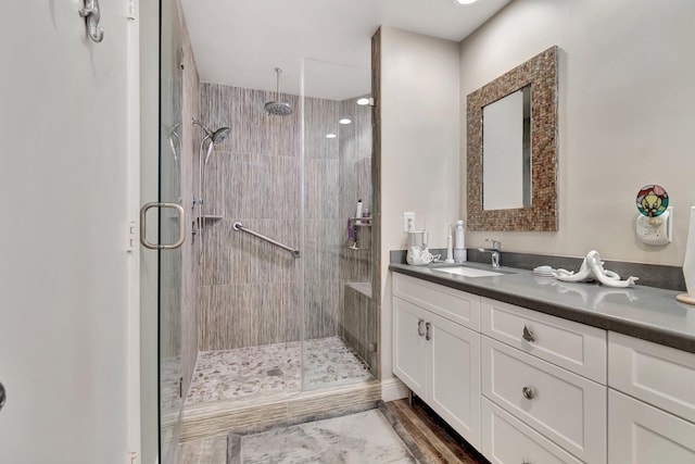 bathroom featuring hardwood / wood-style floors, vanity, and an enclosed shower