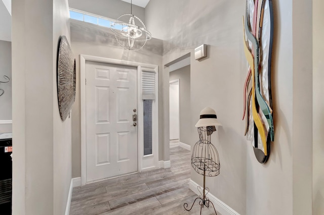 entryway featuring a notable chandelier and light wood-type flooring