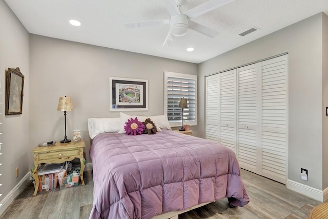 bedroom with ceiling fan, a closet, and light wood-type flooring