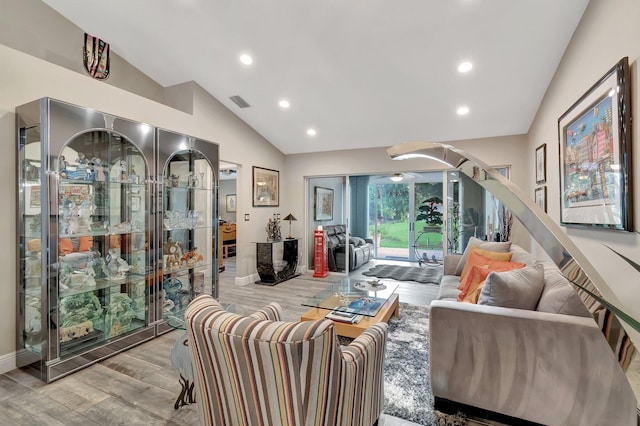 living room featuring light hardwood / wood-style floors and lofted ceiling