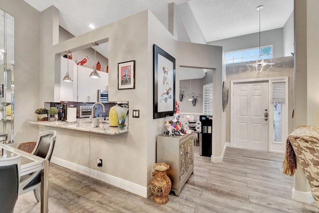 foyer entrance featuring high vaulted ceiling