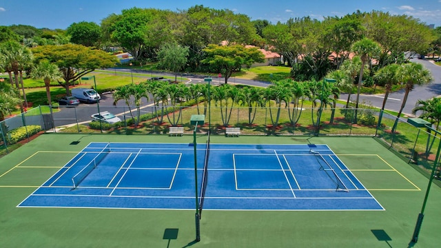 view of tennis court with basketball hoop