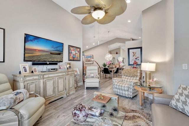 living room featuring ceiling fan, high vaulted ceiling, and light hardwood / wood-style floors