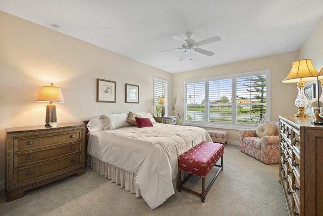 bedroom featuring light colored carpet and ceiling fan