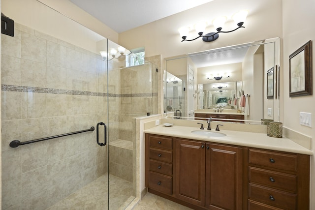 bathroom featuring a shower with door and vanity