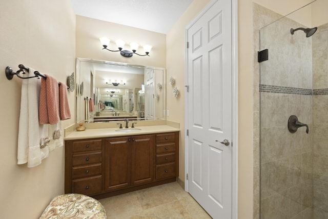 bathroom with vanity and a tile shower