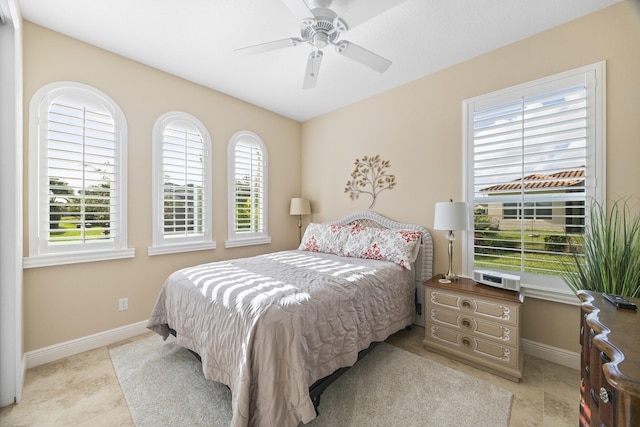 bedroom featuring multiple windows and ceiling fan