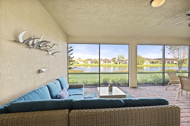 sunroom / solarium featuring a water view