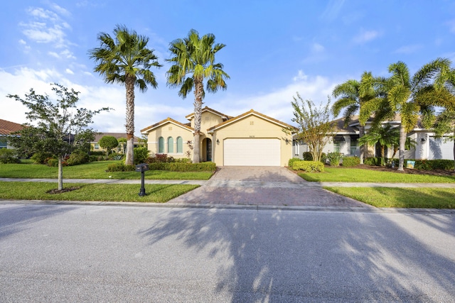 view of front of home with a garage and a front lawn