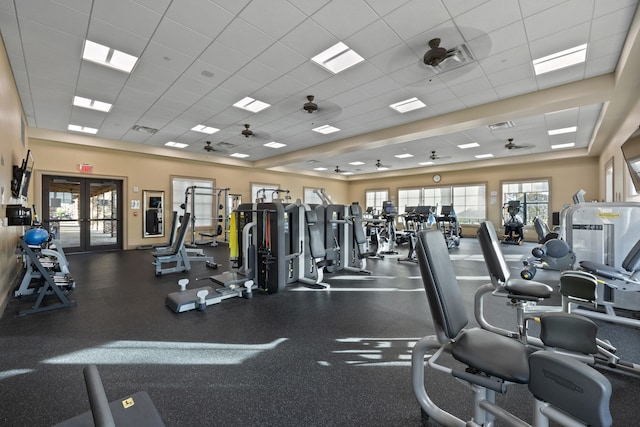 workout area featuring french doors and a paneled ceiling