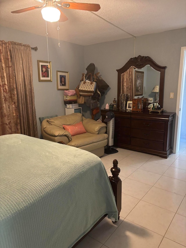 tiled bedroom with a textured ceiling and ceiling fan