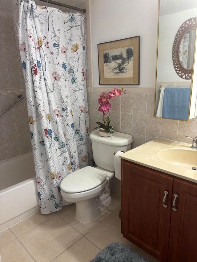 full bathroom with toilet, tile patterned floors, tile walls, vanity, and shower / bathtub combination with curtain