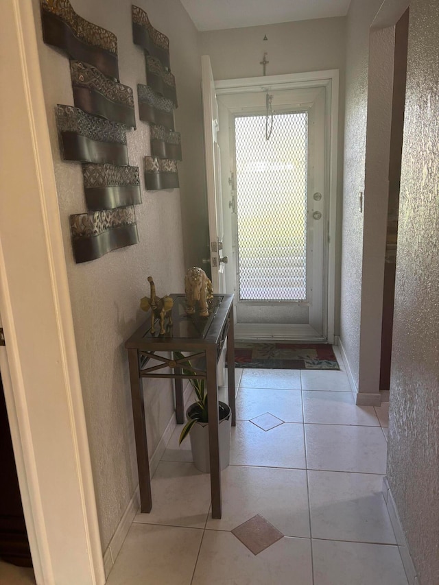 doorway to outside featuring light tile patterned flooring