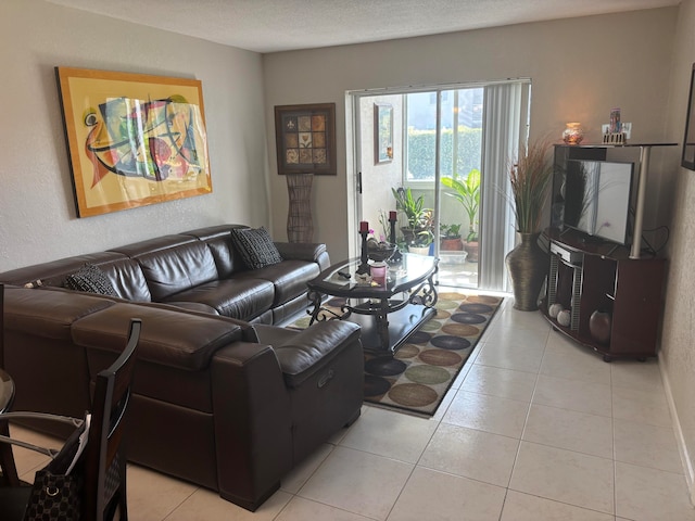 living room with a textured ceiling and light tile patterned floors