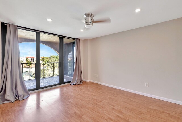 spare room featuring ceiling fan and light hardwood / wood-style flooring