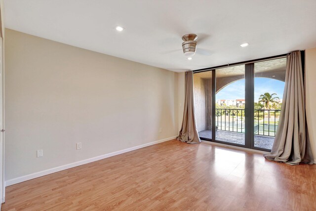 unfurnished room with ceiling fan and light wood-type flooring