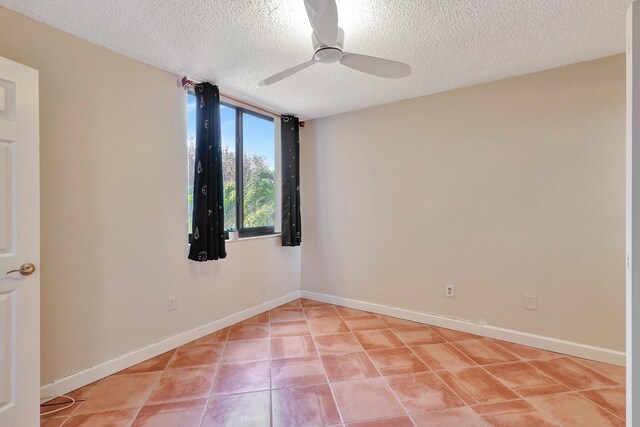 tiled empty room with a textured ceiling and ceiling fan