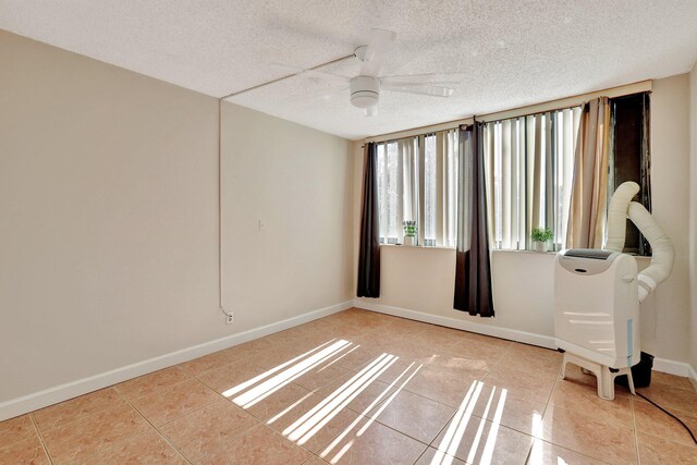 tiled bedroom featuring ceiling fan, a closet, and a textured ceiling