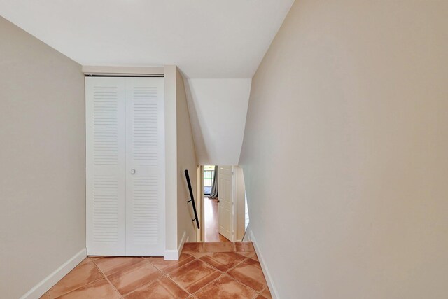 stairway with tile patterned floors