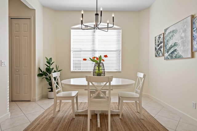 tiled dining room featuring an inviting chandelier