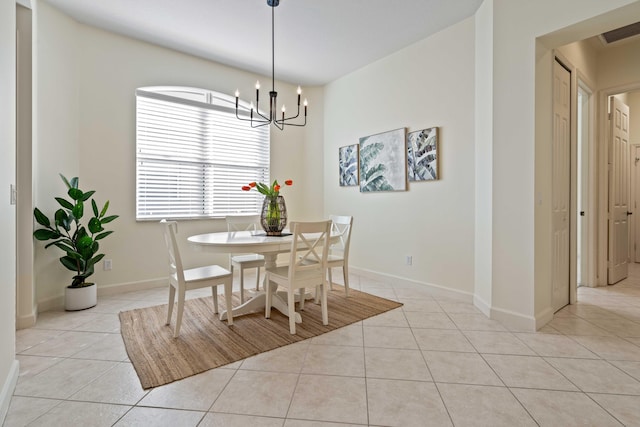 dining room with light tile patterned floors and a notable chandelier