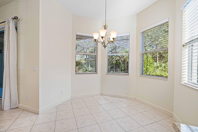 unfurnished dining area featuring a chandelier and light tile patterned floors