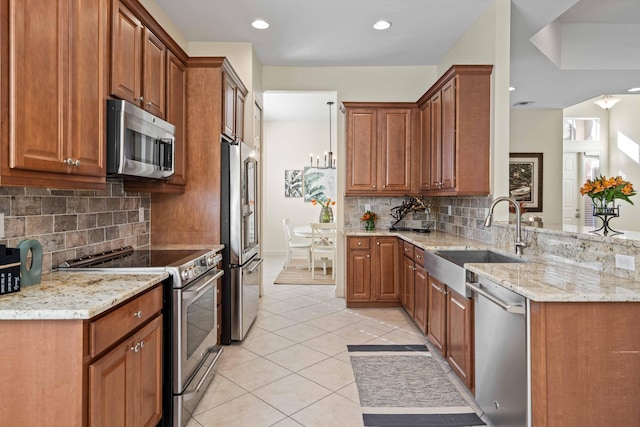 kitchen featuring light stone countertops, stainless steel appliances, light tile patterned flooring, and sink