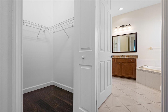 spacious closet with light tile patterned floors