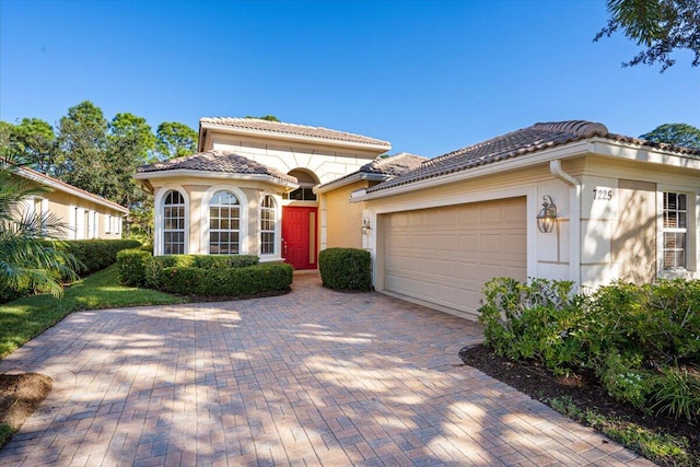 mediterranean / spanish house with a garage