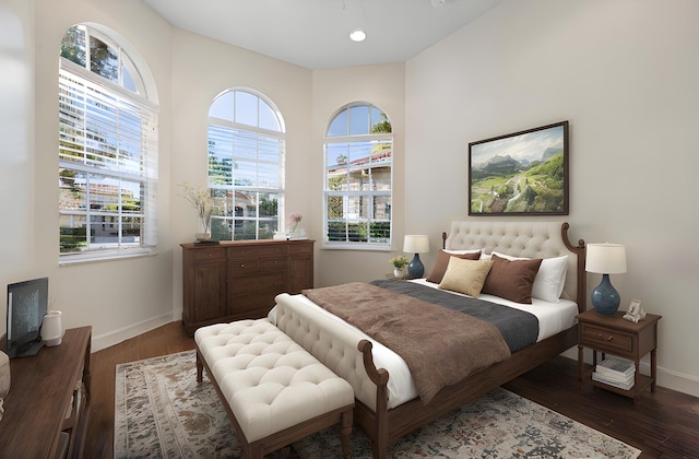 bedroom featuring dark hardwood / wood-style floors and multiple windows