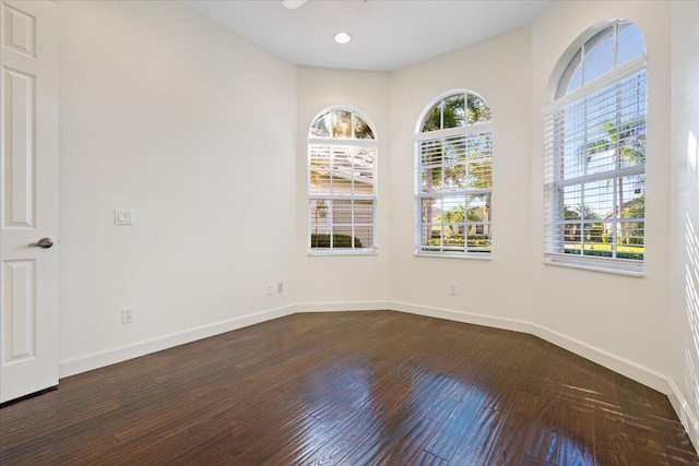 unfurnished room with dark hardwood / wood-style floors