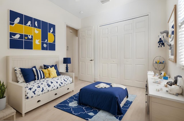 bedroom with a closet and light hardwood / wood-style floors