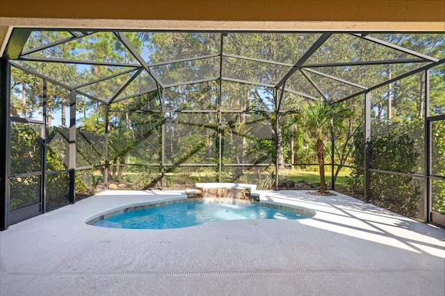 view of pool with pool water feature, glass enclosure, and a patio