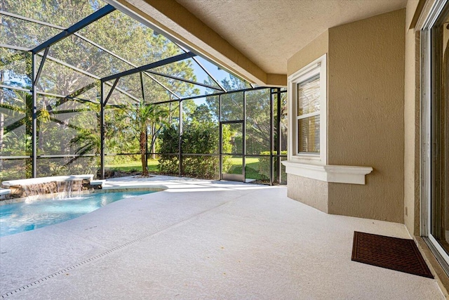 view of swimming pool with pool water feature, glass enclosure, and a patio area