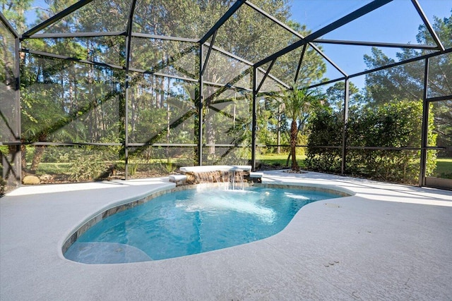 view of pool featuring pool water feature, glass enclosure, and a patio