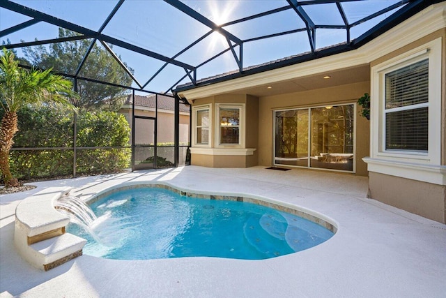 view of pool with pool water feature, glass enclosure, and a patio area