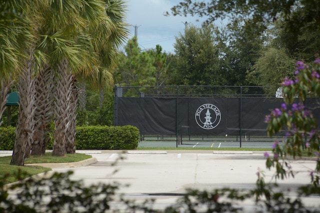 view of community featuring tennis court