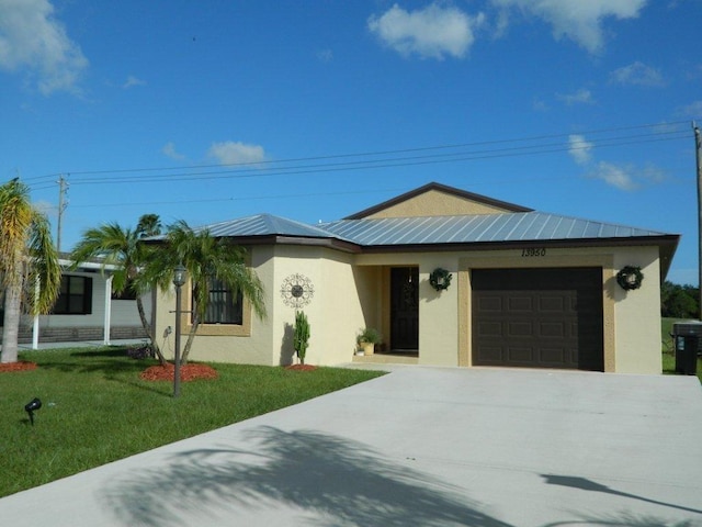 ranch-style house featuring a garage and a front lawn