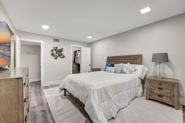 bedroom featuring light hardwood / wood-style floors, a closet, and a spacious closet