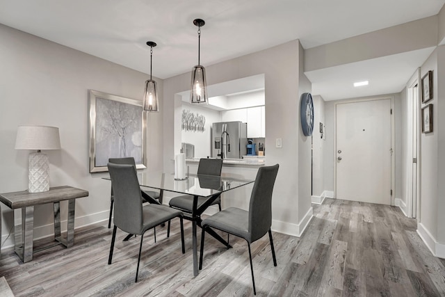 dining space with hardwood / wood-style flooring