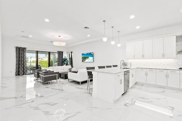 13689 Artisan Cir, Palm Beach Gardens, FL 33418 - kitchen featuring dishwasher, a sink, white cabinetry, a peninsula, and tasteful backsplash