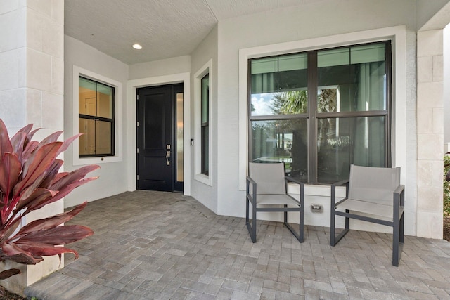 property entrance featuring a patio