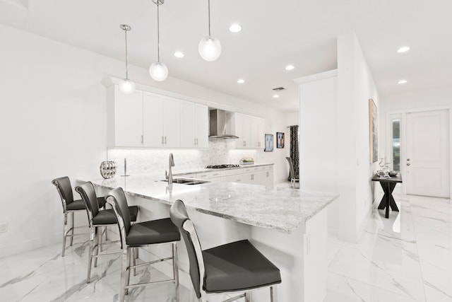 13689 Artisan Cir, Palm Beach Gardens, FL 33418 - kitchen with a sink, wall chimney range hood, tasteful backsplash, recessed lighting, and gas cooktop