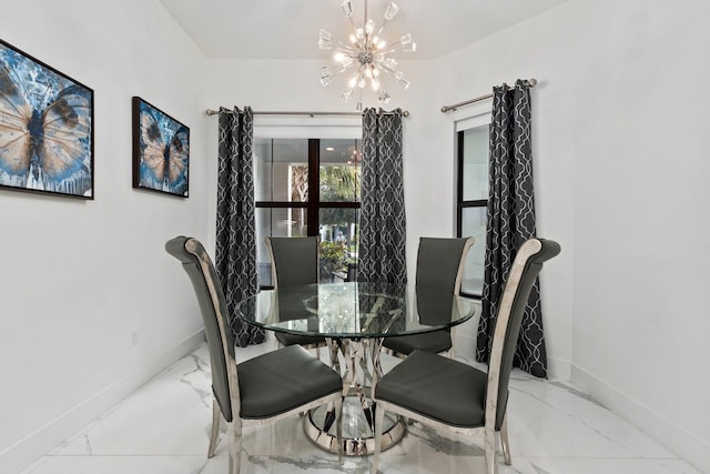 13689 Artisan Cir, Palm Beach Gardens, FL 33418 - dining room with baseboards, marble finish floor, and a notable chandelier