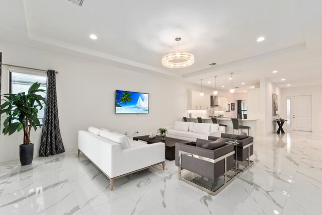 13689 Artisan Cir, Palm Beach Gardens, FL 33418 - living room with marble finish floor, visible vents, a tray ceiling, and recessed lighting