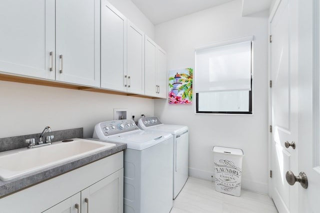 13689 Artisan Cir, Palm Beach Gardens, FL 33418 - laundry room featuring baseboards, washer and dryer, cabinet space, and a sink