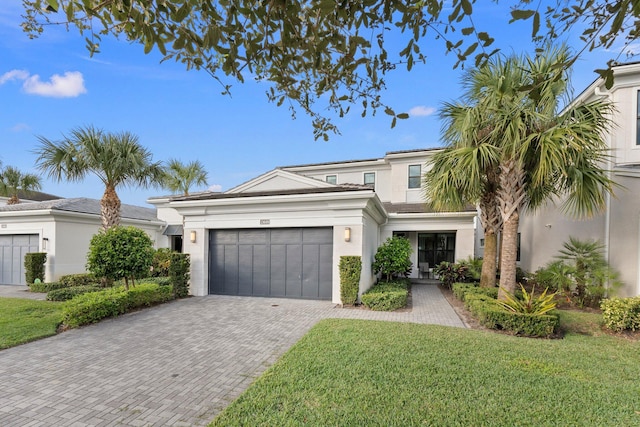 view of front of house with a garage and a front lawn