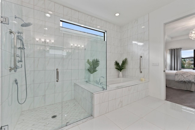 bathroom with tile patterned floors and independent shower and bath